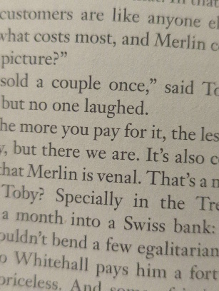 A picture taken from a cell phone of a fragment of a page of a book with the text ... "that Merlin is venal. That's an"...